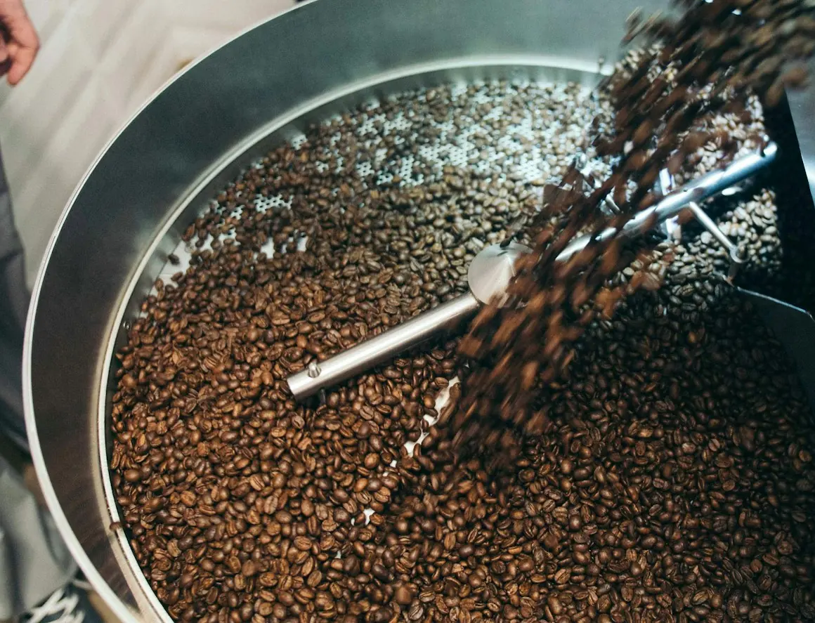 Coffee beans pouring from the roaster into the cooling tray
